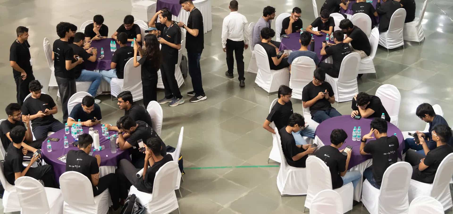 The evening social from above: contestants around tables after the Derive '26 finals